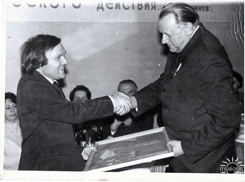 Lecturer A. F. Bakum congratulates former director P.K. Patsey. 1979